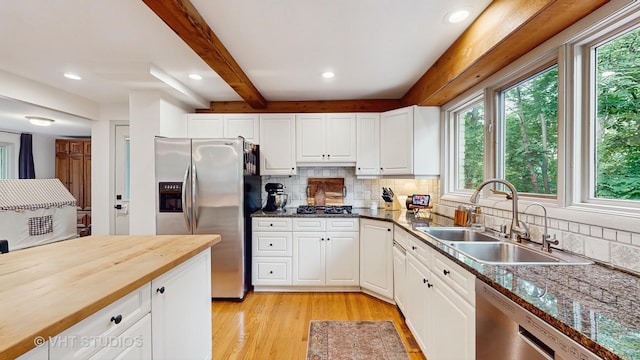 11649 S Walnut Ridge Dr, Palos Park, IL 60464 - kitchen featuring appliances with stainless steel finishes, beam ceiling, backsplash, light wood-style floors, and butcher block countertops