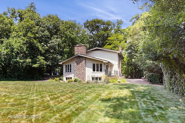 11649 S Walnut Ridge Dr, Palos Park, IL 60464 - view of side of home with a chimney, a lawn, and brick siding