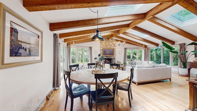 11649 S Walnut Ridge Dr, Palos Park, IL 60464 - dining space with a skylight, plenty of natural light, a stone fireplace, and light wood finished floors