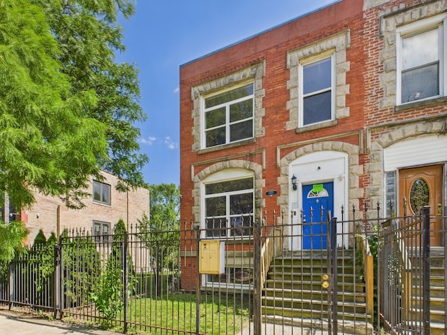 2933 W Wilcox St, Chicago, IL 60612 - view of property featuring a fenced front yard and brick siding