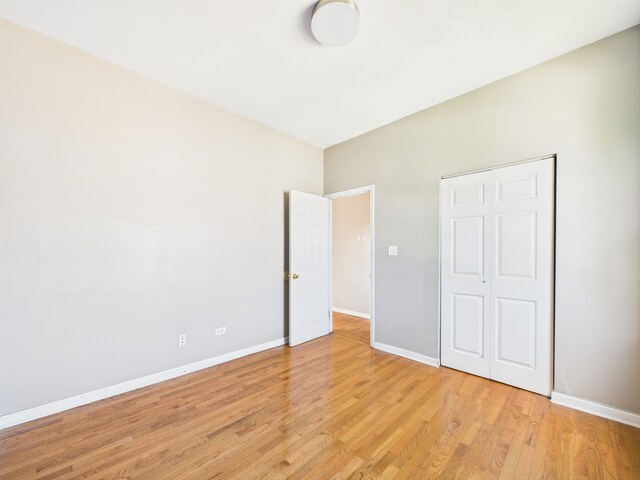 2933 W Wilcox St, Chicago, IL 60612 - unfurnished bedroom featuring baseboards and light wood-style flooring