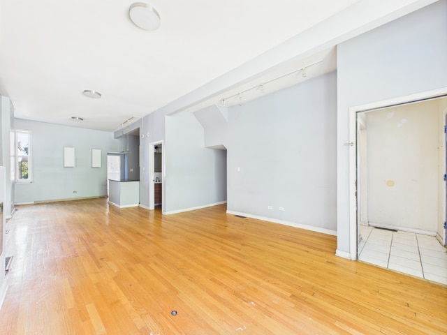 2933 W Wilcox St, Chicago, IL 60612 - unfurnished living room featuring light wood-type flooring and baseboards