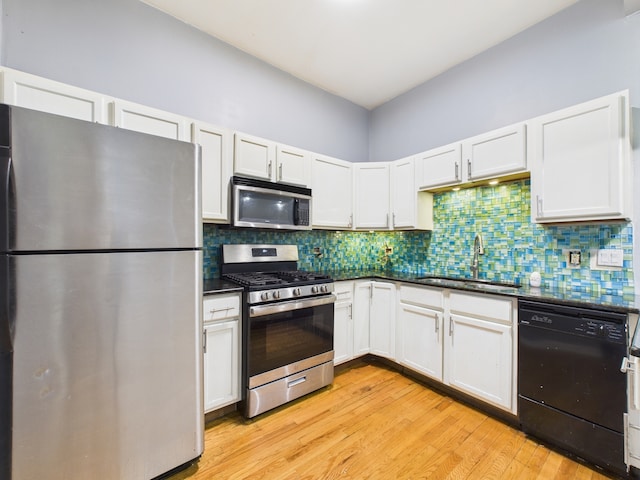 2933 W Wilcox St, Chicago, IL 60612 - kitchen featuring stainless steel appliances, light wood-style floors, white cabinetry, and tasteful backsplash