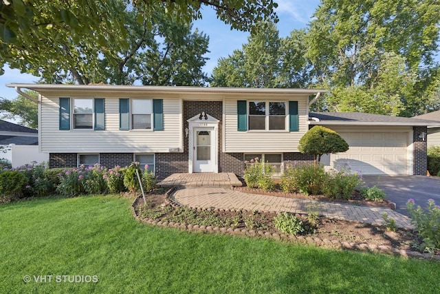 2140 Baker St, Aurora, IL 60506 - bi-level home featuring brick siding, a front lawn, an attached garage, and asphalt driveway