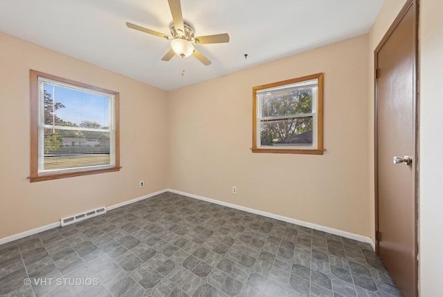 2140 Baker St, Aurora, IL 60506 - empty room featuring a ceiling fan and baseboards