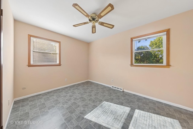 2140 Baker St, Aurora, IL 60506 - empty room featuring a ceiling fan and baseboards