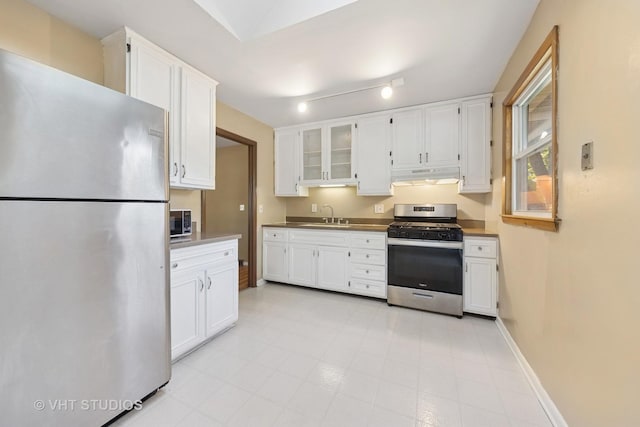 2140 Baker St, Aurora, IL 60506 - kitchen with appliances with stainless steel finishes, under cabinet range hood, and white cabinets