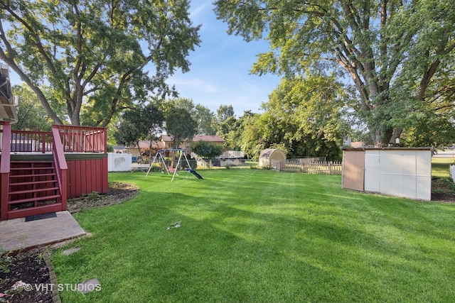 2140 Baker St, Aurora, IL 60506 - fenced backyard featuring a storage shed, a playground, a deck, and stairs