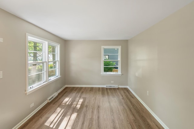 14348 Knox Ave, Midlothian, IL 60445 - unfurnished room featuring wood finished floors and plenty of natural light