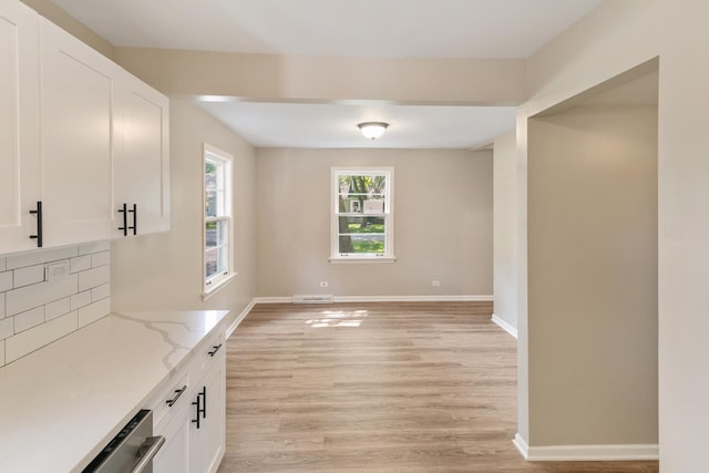 14348 Knox Ave, Midlothian, IL 60445 - unfurnished dining area featuring light wood-style flooring and baseboards