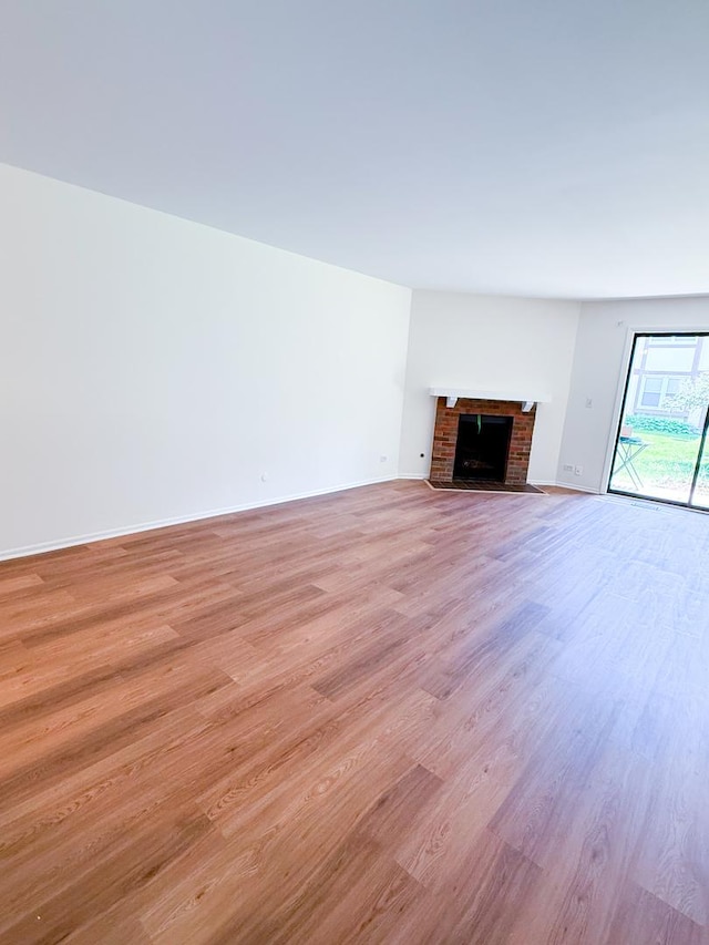 4640 Calvert Dr Unit B1, Rolling Meadows, IL 60008 - unfurnished living room with light wood-style floors and a fireplace