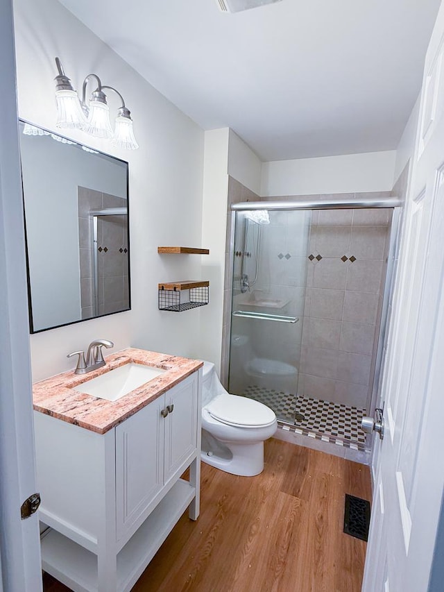 4640 Calvert Dr Unit B1, Rolling Meadows, IL 60008 - full bathroom featuring wood finished floors, a shower stall, and vanity