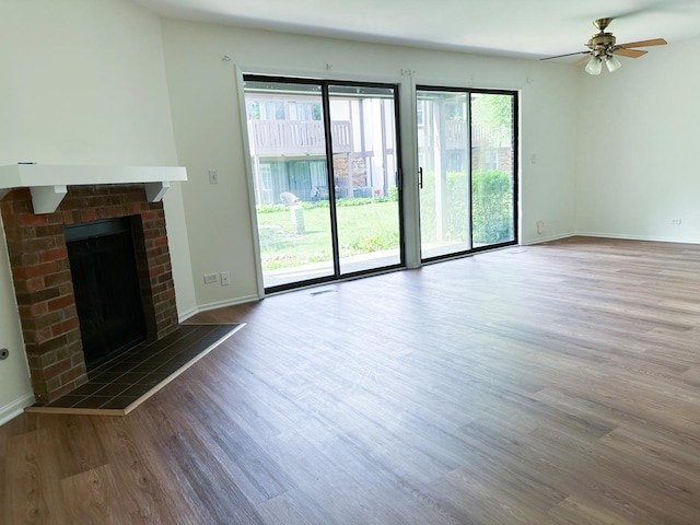 4640 Calvert Dr Unit B1, Rolling Meadows, IL 60008 - unfurnished living room featuring wood finished floors, a ceiling fan, and a brick fireplace