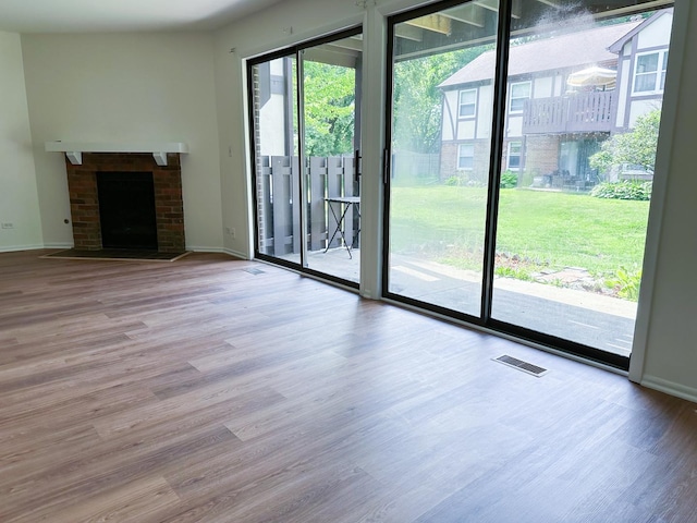 4640 Calvert Dr Unit B1, Rolling Meadows, IL 60008 - unfurnished living room with wood finished floors and a fireplace