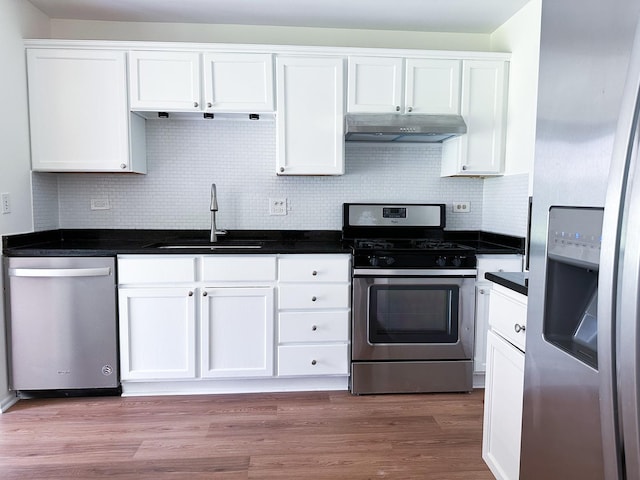 4640 Calvert Dr Unit B1, Rolling Meadows, IL 60008 - kitchen featuring stainless steel appliances, under cabinet range hood, white cabinetry, dark countertops, and decorative backsplash