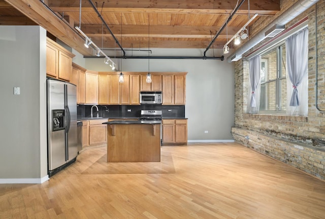 1740 N Maplewood Ave Unit 218, Chicago, IL 60647 - kitchen featuring stainless steel appliances, a wooden ceiling with exposed beams, brick wall, tasteful backsplash, and a kitchen island