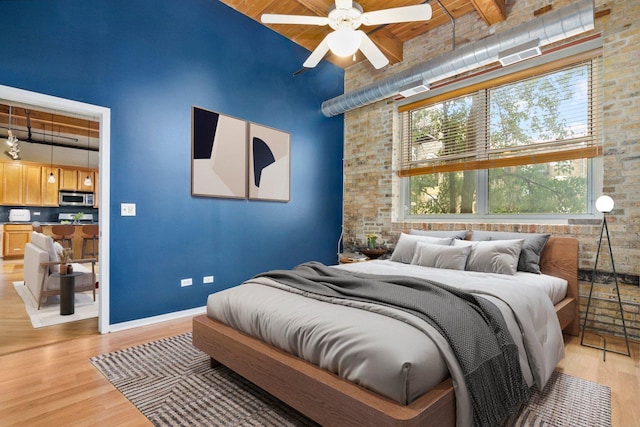 1740 N Maplewood Ave Unit 218, Chicago, IL 60647 - bedroom featuring a wooden ceiling with exposed beams, a towering ceiling, and light wood finished floors