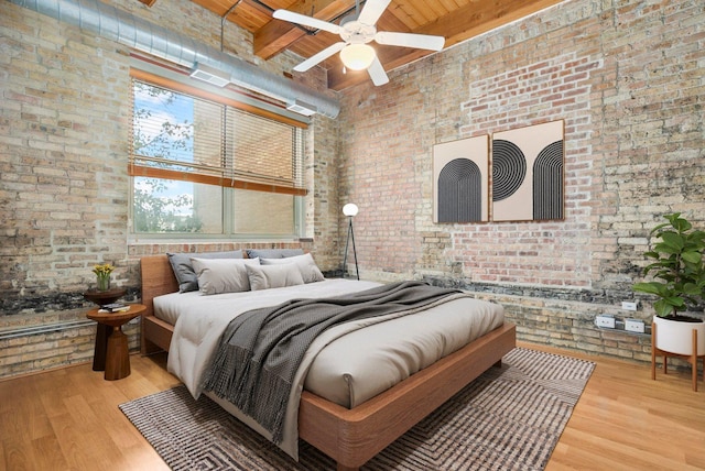 1740 N Maplewood Ave Unit 218, Chicago, IL 60647 - bedroom featuring brick wall, a towering ceiling, a wood ceiling with exposed beams, and wood finished floors