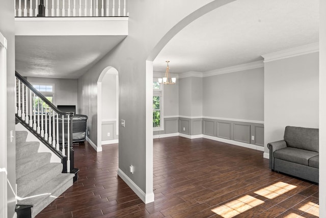 2913 Fox Creek Rd, Bloomington, IL 61705 - entryway featuring arched walkways, wood finished floors, stairway, a chandelier, and ornamental molding