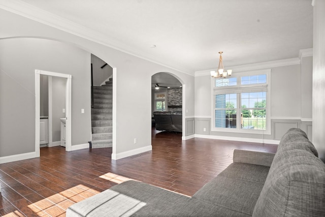 2913 Fox Creek Rd, Bloomington, IL 61705 - unfurnished living room featuring arched walkways, wood finished floors, a chandelier, stairway, and ornamental molding
