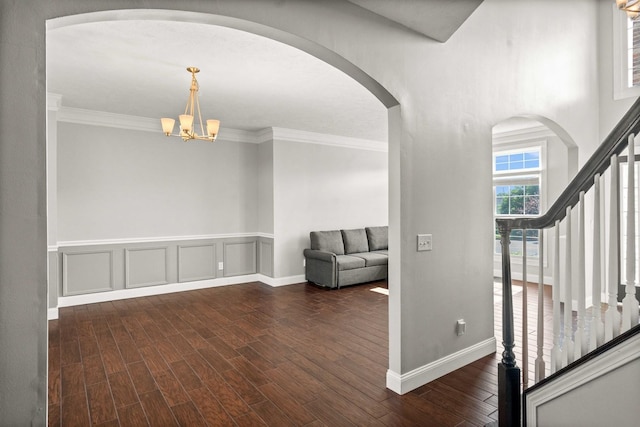 2913 Fox Creek Rd, Bloomington, IL 61705 - entryway with arched walkways, dark wood-type flooring, stairs, a chandelier, and crown molding