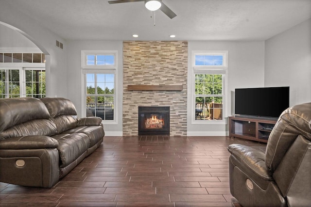 2913 Fox Creek Rd, Bloomington, IL 61705 - living room featuring ceiling fan, healthy amount of natural light, a stone fireplace, wood tiled floors, and recessed lighting