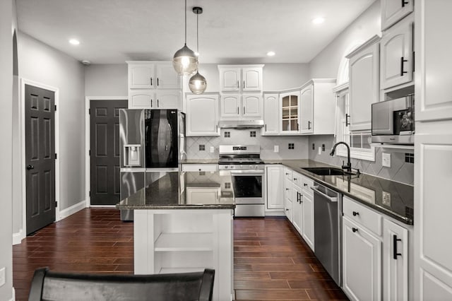2913 Fox Creek Rd, Bloomington, IL 61705 - kitchen featuring appliances with stainless steel finishes, under cabinet range hood, dark wood-type flooring, white cabinetry, and recessed lighting