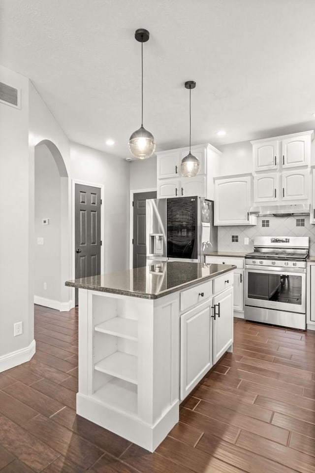2913 Fox Creek Rd, Bloomington, IL 61705 - kitchen with appliances with stainless steel finishes, open shelves, arched walkways, a center island, and white cabinetry