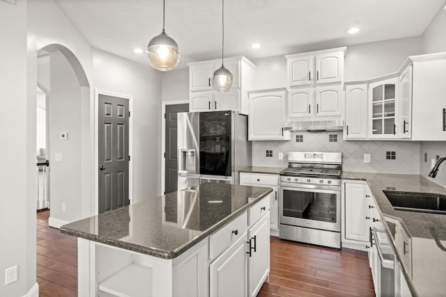 2913 Fox Creek Rd, Bloomington, IL 61705 - kitchen featuring appliances with stainless steel finishes, dark wood-style floors, arched walkways, white cabinetry, and recessed lighting