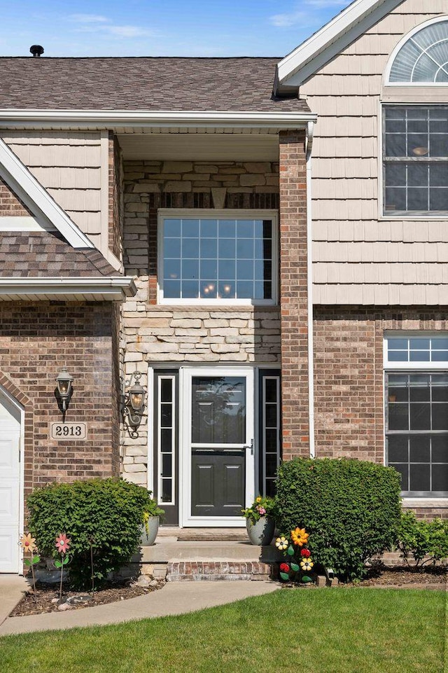 2913 Fox Creek Rd, Bloomington, IL 61705 - view of exterior entry with brick siding and roof with shingles