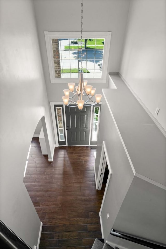 2913 Fox Creek Rd, Bloomington, IL 61705 - foyer entrance featuring wood finished floors, a chandelier, a towering ceiling, and arched walkways