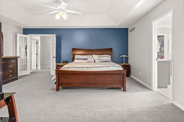 2913 Fox Creek Rd, Bloomington, IL 61705 - bedroom with a tray ceiling, carpet flooring, and french doors