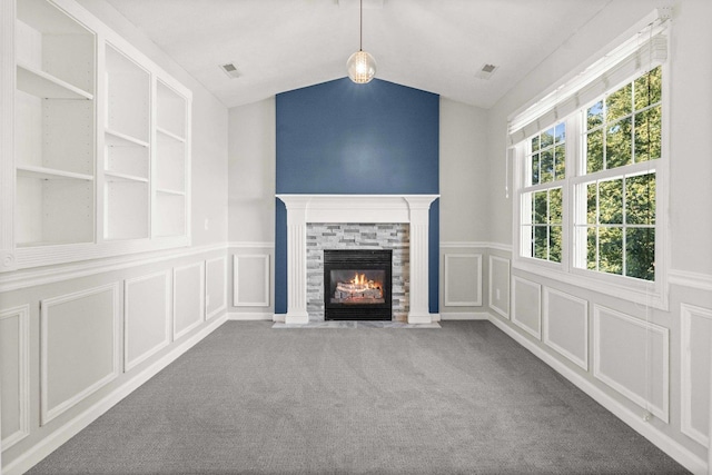 2913 Fox Creek Rd, Bloomington, IL 61705 - unfurnished living room featuring a decorative wall, a fireplace with flush hearth, lofted ceiling, carpet, and wainscoting