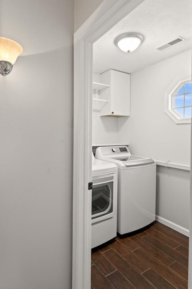 2913 Fox Creek Rd, Bloomington, IL 61705 - washroom with cabinet space, separate washer and dryer, and dark wood-style floors