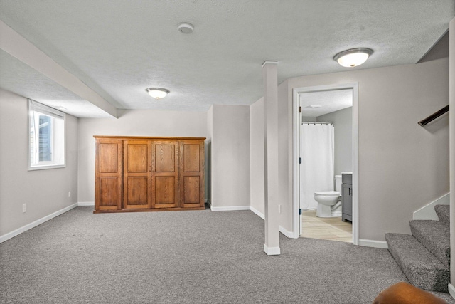 2913 Fox Creek Rd, Bloomington, IL 61705 - basement with light colored carpet, a textured ceiling, and stairway