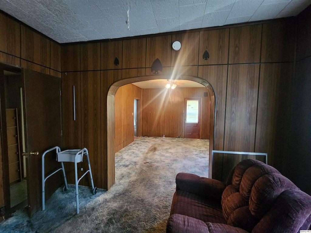 525 Chestnut, Quincy, IL 62301 - living room featuring arched walkways, carpet floors, and wood walls