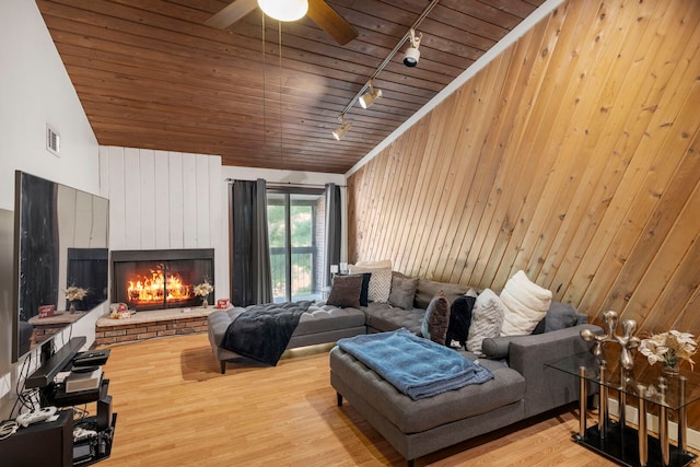 14505 Central Ct Unit Ph4, Oak Forest, IL 60452 - living area with rail lighting, wooden ceiling, wood walls, a fireplace, and ceiling fan