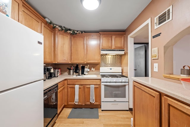 14505 Central Ct Unit Ph4, Oak Forest, IL 60452 - kitchen with white appliances, under cabinet range hood, light wood-style flooring, light countertops, and arched walkways