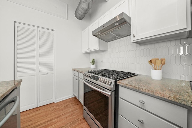 1645 W School St Unit 318, Chicago, IL 60657 - kitchen with stainless steel gas stove, wall chimney range hood, light wood finished floors, light stone countertops, and tasteful backsplash