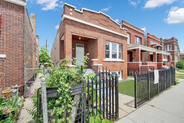5322 W 22nd Pl, Cicero, IL 60804 - view of front facade with brick siding, a fenced front yard, and a gate