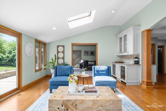 4211 Legend Ct, Naperville, IL 60564 - living room featuring wine cooler, a bar, light wood finished floors, lofted ceiling, and stairway