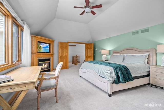 4211 Legend Ct, Naperville, IL 60564 - carpeted bedroom featuring vaulted ceiling, a glass covered fireplace, and a ceiling fan