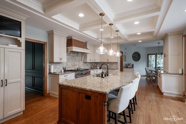 4211 Legend Ct, Naperville, IL 60564 - kitchen with custom range hood, high end stainless steel range oven, coffered ceiling, light stone counters, and a breakfast bar