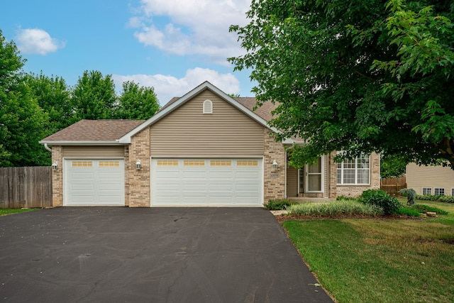 10578 Harrison Ct, Roscoe, IL 61073 - view of front facade featuring brick siding, asphalt driveway, a garage, and roof with shingles
