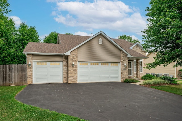 10578 Harrison Ct, Roscoe, IL 61073 - view of front of home featuring driveway, brick siding, an attached garage, and roof with shingles