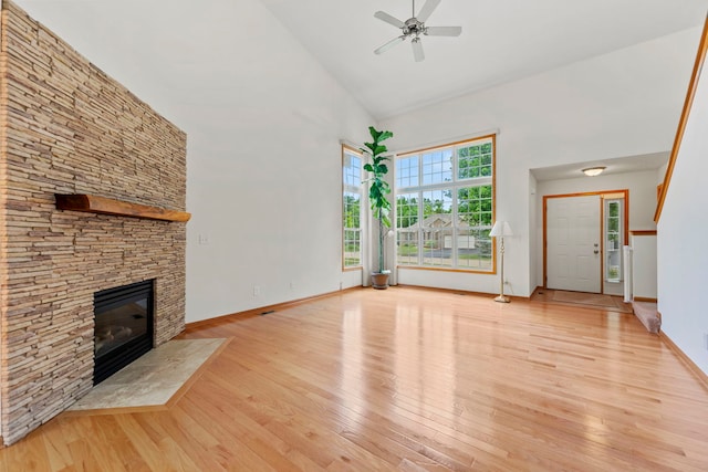 10578 Harrison Ct, Roscoe, IL 61073 - unfurnished living room with high vaulted ceiling, a ceiling fan, a fireplace, and light wood-style flooring
