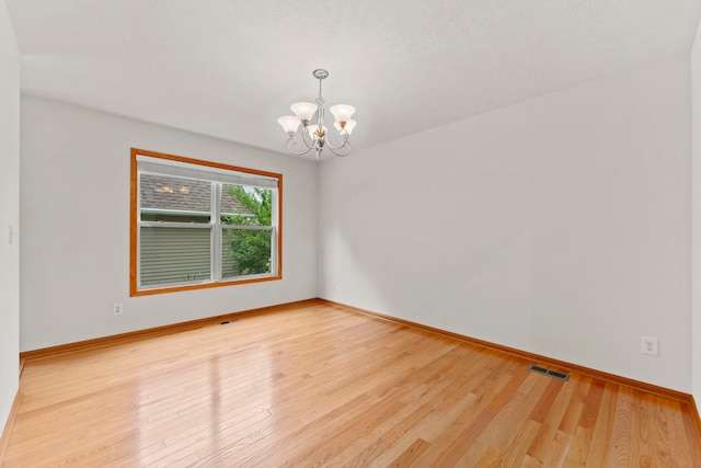 10578 Harrison Ct, Roscoe, IL 61073 - empty room with a chandelier and wood finished floors