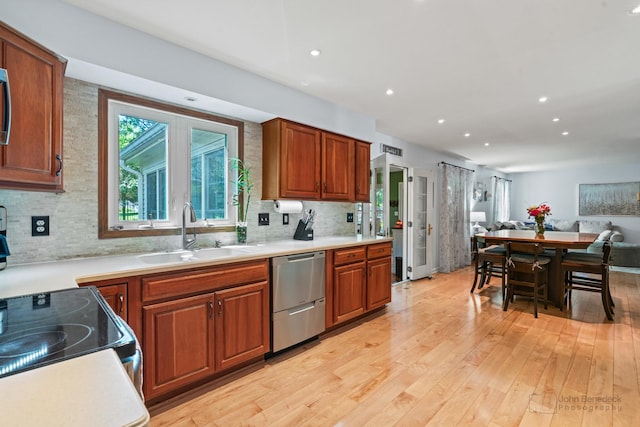 1120 Bennington Dr, Crystal Lake, IL 60014 - kitchen with dishwasher, open floor plan, light wood finished floors, tasteful backsplash, and brown cabinets