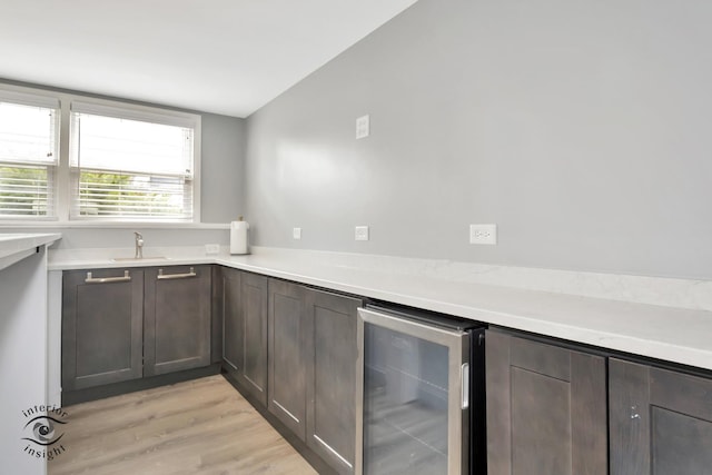 7027 174th Pl, Tinley Park, IL 60477 - kitchen with wine cooler, light wood-type flooring, light countertops, and dark brown cabinets