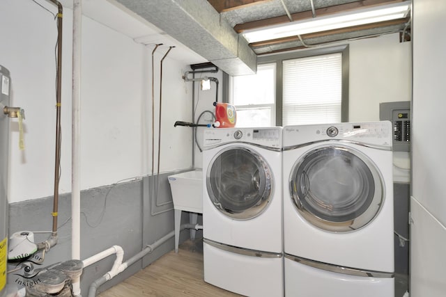 7027 174th Pl, Tinley Park, IL 60477 - washroom featuring light wood finished floors, washer and clothes dryer, and electric panel